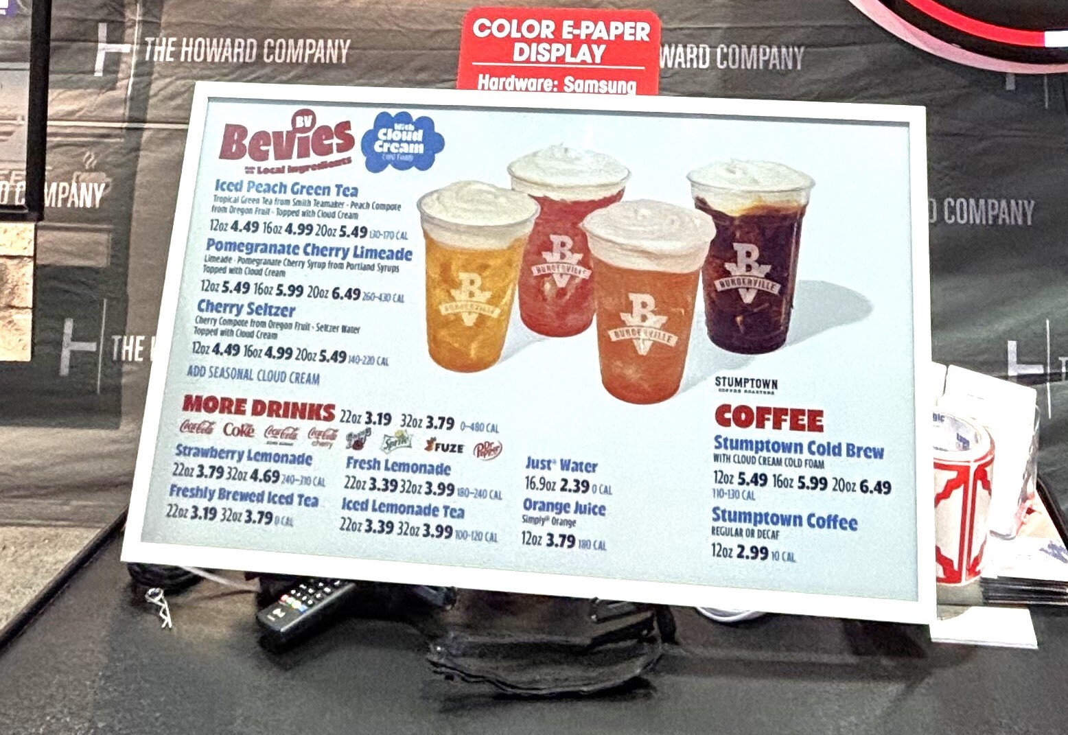 Printed menu board displaying a beverage menu with drink photos and pricing, produced by The Howard Company Printed menu board displaying a beverage menu with drink photos and pricing, produced by The Howard Company