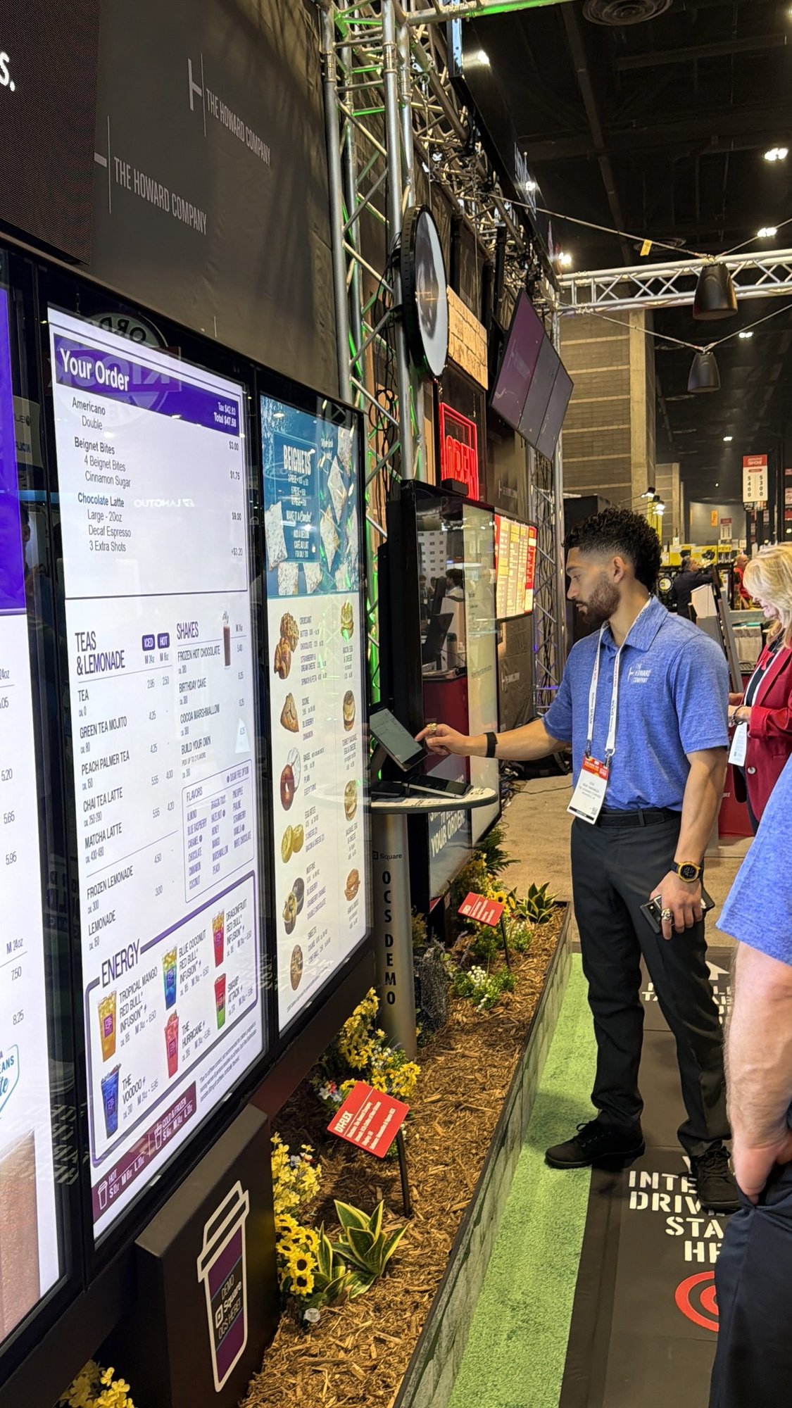 Howard Company's Erik demoing Square OCS on a DT-Flex digital drive thru menu board at NRA 2026